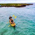 Kayakers paddling their rental kayak in Kailua near Flat Island
