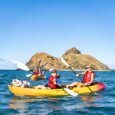 A mother and son kayaking to the mokulua Islands in Kailua