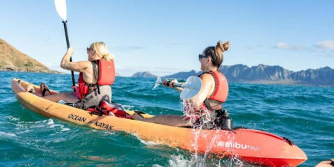 Two kayakers paddling to kailua's twin islands